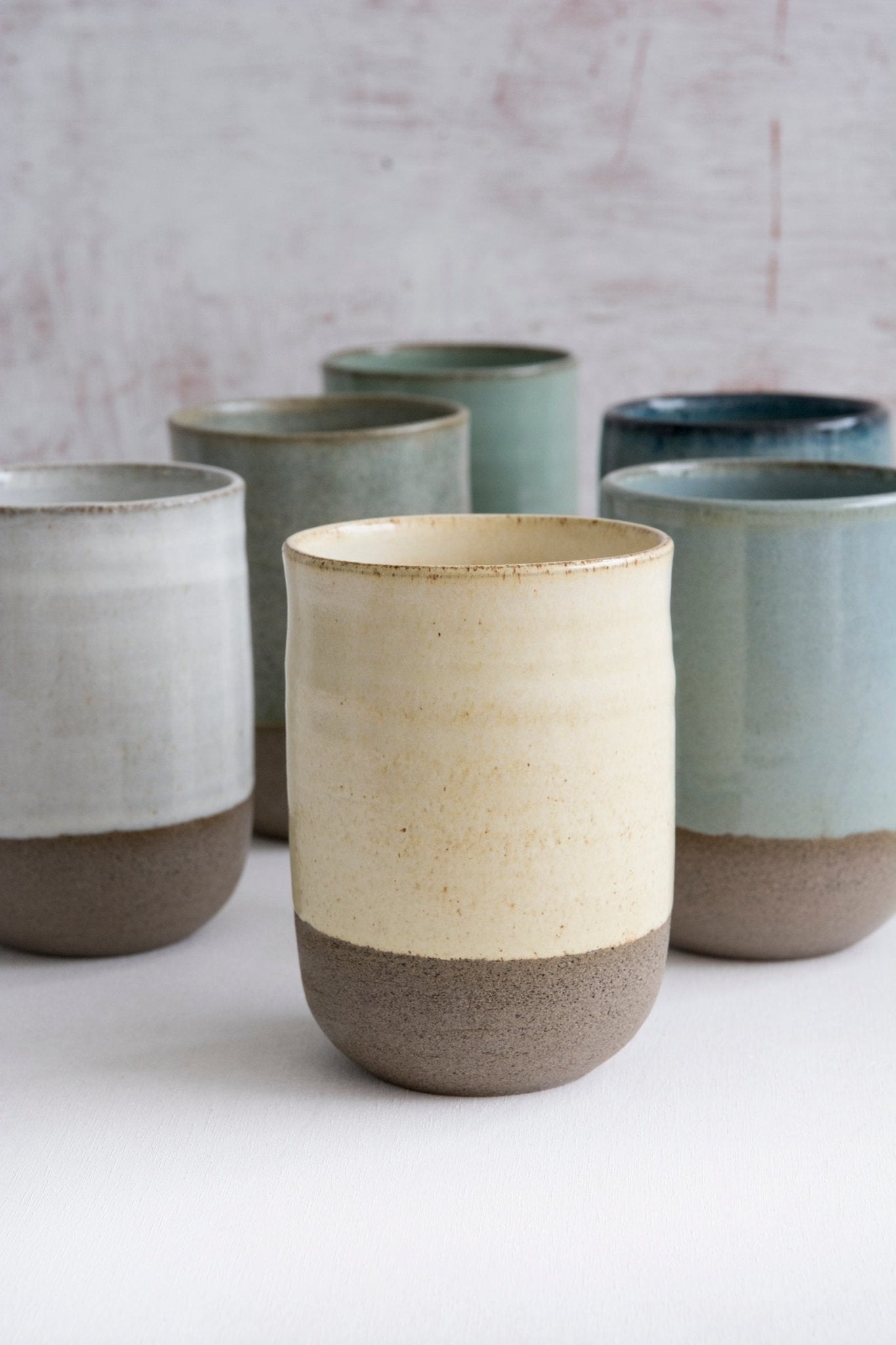 Set of colorful handmade pottery iced coffee tumblers, showcasing the mix and match color options