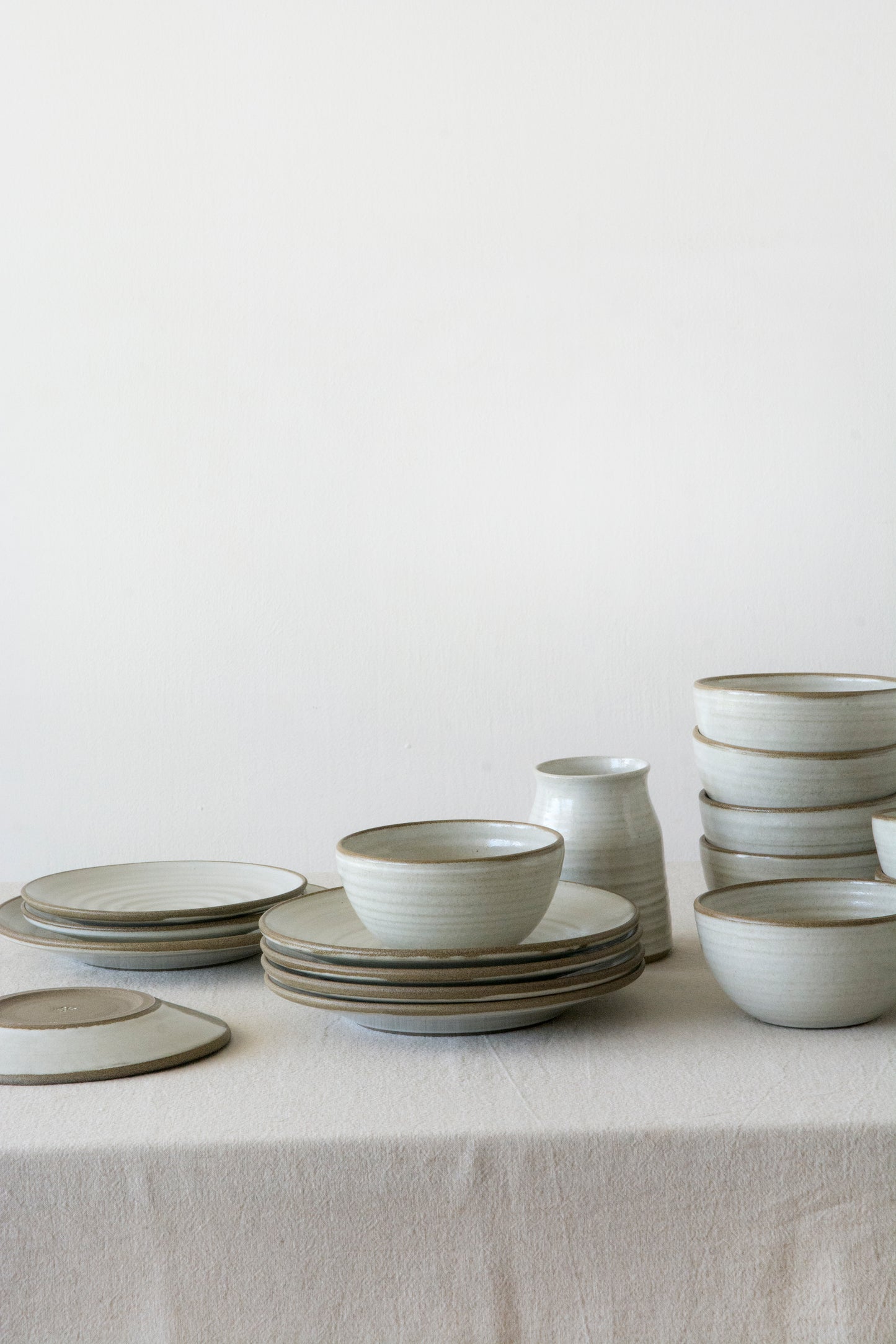 Wheel-thrown stoneware bowl in matte white glaze, showing the natural brown rim of the clay.
