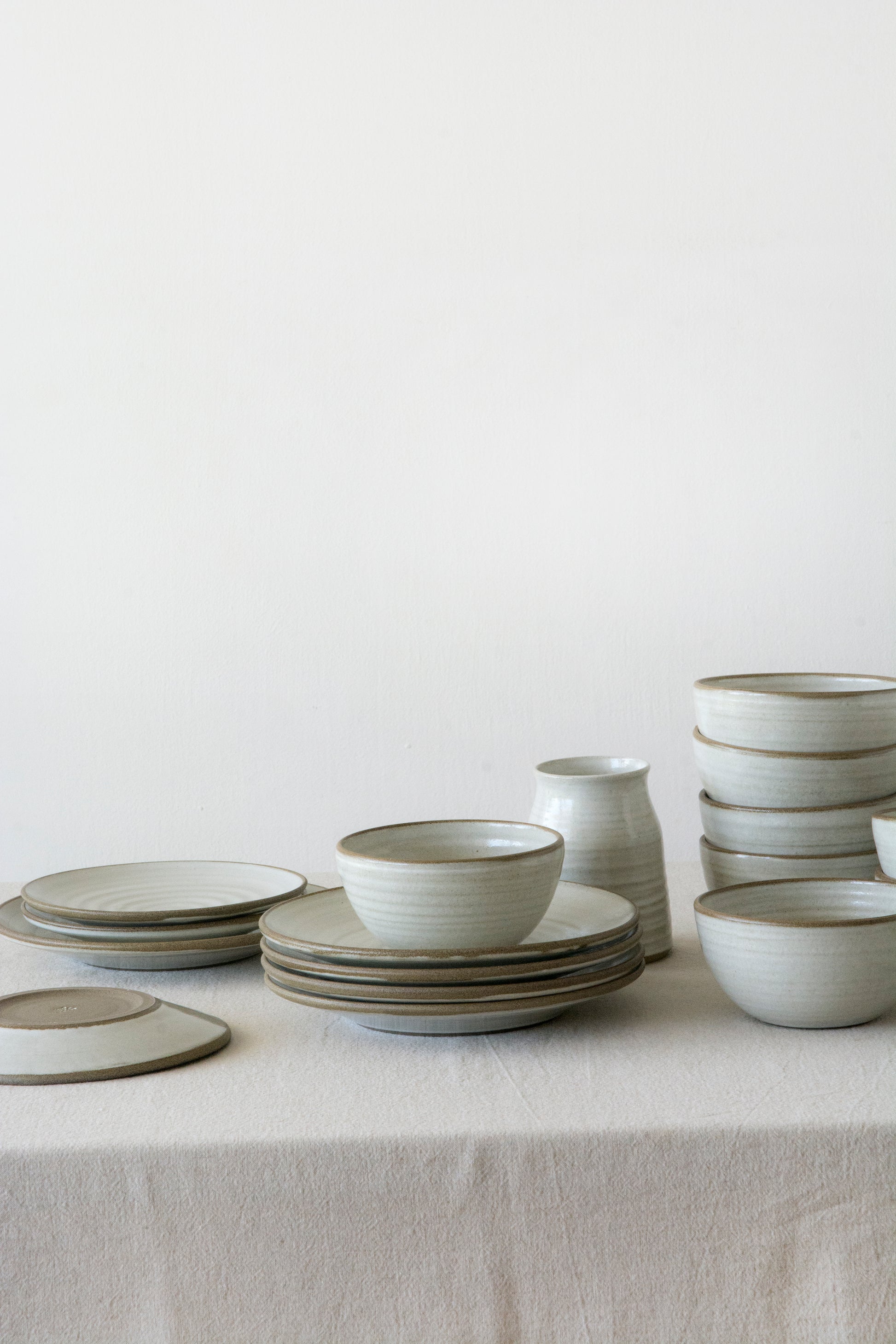 Wheel-thrown stoneware bowl in matte white glaze, showing the natural brown rim of the clay.